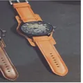 Classic sporty men's wristwatch featuring an oversized black dial and orange leather strap. - Yellow