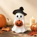 Detail view of a ceramic ghost figurine holding a pumpkin in a cozy Halloween setting - No Light Style