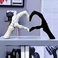 Detailed view of black and white skeleton hands forming a heart shape ornament - S / Black and White