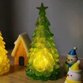 Macro view of a green crystal star Christmas tree night light with warm LED glow - Green