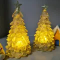 Detailed close-up view of two yellow crystal Christmas tree night lights with glowing stars - Yellow