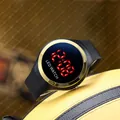 Close-up detail of a waterproof LED digital watch with golden bezel and black strap - Round LED Watch / Gold