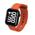 Detailed view of a vibrant orange LED digital sports watch featuring a black square face - Orange