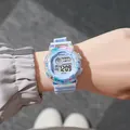 Close-up of a student digital watch with macaron gradient case and blue strap - Blue