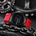 Close-up of black digital sports watch with red silicone strap and metal chain - Red