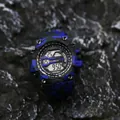 Detailed close-up of a rugged military camouflage digital watch on a dark rock surface - Camouflage Blue