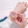 Detailed view of a transparent pink digital sports watch worn on a wrist over a keyboard - Pink
