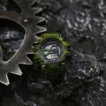 Close-up of green camouflage digital sports watch against rugged background. - Camo Green