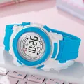 Gros plan d'une montre de sport numérique bleue et blanche pour enfants avec bracelet - Bleu clair