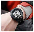 Macro detail of a black digital sports watch with SIKEZHUN logo on a male wrist - Black