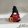 Detailed close-up of a resin Halloween gnome figurine with a red beard and pumpkin. - Vampire Style