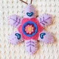 Close-up of handmade purple felt snowflake ornament with colorful embroidery - Purple Snowflake (202640) / Purple Material Pack