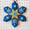 Detailed view of handmade blue felt Christmas snowflake ornament with embroidery - Blue Snowflake (202640) / Blue Material Pack
