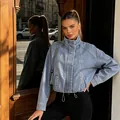 Fashionable light blue women's denim jacket featuring a chic stand collar and drawstring waist - S / Tops / Blue