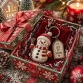 Detail of a snowman keychain with 'LET IT SNOW' tag in a festive Christmas gift box - Snowman Gift Box / Snowman