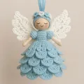 Primer plano de un pequeño ángel de ganchillo azul claro hecho a mano con madera - Azul