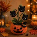 Close-up of a handmade crochet Halloween pumpkin pot with black cat heads - Black Cat Style
