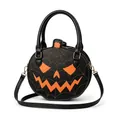 Detail view of a black Halloween pumpkin handbag with orange spider web embroidery. - Black With Orange Face (Style C)