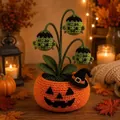 Detail of a handmade crochet Halloween pumpkin pot with Frankenstein flower heads - Green Phantom Style