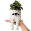 Detailed macro view of a creative mummy resin planter with hanging legs for Halloween - Mummy