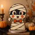 Close-up of a cute wooden mummy character tabletop decoration for Halloween scene - Cartoon Mummy (C)