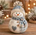 Detailed view of a cozy quilted fabric snowman with a knitted hat and heart patch decoration. - Christmas Snowman (C)