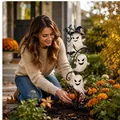 Solar Halloween ghost garden stake light being placed in an autumn outdoor garden - Ghost 3-String Night Light