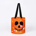 Detailed view of Halloween candy bucket with glowing LED lights and skull face - Orange