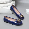 Close-up view of elegant glossy blue ballet flats featuring a stylish golden heart buckle - Dark Blue