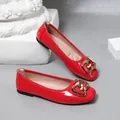 Close-up of red glossy square-toe ballet flats with elegant gold heart-shaped buckle. - 35 / Red