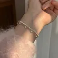 Detailed macro shot of an elegant double-layered white pearl bracelet on a lady's wrist. - Double Layer Pearl Chain Style (MY36454)