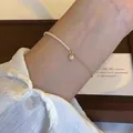 Close-up detail of an elegant gold chain bracelet with delicate white pearls worn on a wrist - Pearl Thin Chain Splicing Style (MY36355)