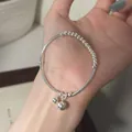 Detailed macro view of a minimalist silver bead bracelet with ball charms - Double Sphere Charm Style (MY35972)