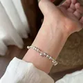 Detailed view of minimalist silver bead bracelet with delicate hanging charms on wrist - Silver Bead Tassel Style (MY36157)