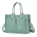 Close-up detail of sage green canvas tote bag with multiple pockets and wide strap - H 25cm W 14cm L 34cm / Green