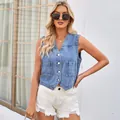 Detailed view of the women's slim fit washed denim vest with V-neckline and silver buttons - S / Tops / Blue
