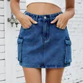 Close-up detail of a vintage washed blue denim cargo mini skirt with flap pockets. - S / Bottoms / Dark Blue