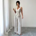Elegante completo beige da donna con gilet senza maniche e pantaloni larghi con profili neri - Taglia S / Top E Pantaloni / Albicocca