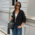 Stylish women's black cropped jacket with long sleeves for a casual chic autumn look. - S / Tops / Black