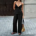 Elegant black two-piece vacation set featuring a deep V-neck camisole and wide-leg pants - Black