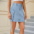 Detail of light blue denim cargo mini skirt featuring utility pockets and long straps. - S / Bottoms / Light Blue