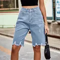 Detailed view of light blue distressed denim bermuda shorts featuring frayed raw hems - S / Bottoms / Light Blue
