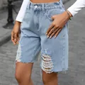 Detailed macro view of light wash distressed denim bermuda shorts with raw frayed hems - 2XL / Bottoms / Light Blue
