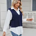 Close-up of navy blue V-neck cable knit sweater vest layered over a white long-sleeve shirt - S / Tops / Sapphire Blue