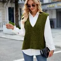 Street style view of a woman wearing a green V-neck cable-knit sleeveless sweater vest. - S / Tops / Army Green