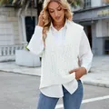Detailed view of woman wearing white cable knit V-neck sweater vest in urban street setting - S / Tops / White
