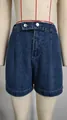 Close-up detail of women's high waisted dark blue washed denim shorts with silver buttons - S / Bottoms / Blue