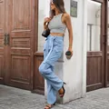 Detailed view of high waisted light blue washed denim cargo pants with functional pockets - S / Bottoms / Indigo