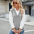 Stylish grey V-neck knit vest layered over a white shirt in a chic urban setting. - S / Tops / Gray