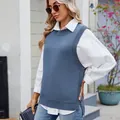 Close-up view of a stylish blue knitted vest with decorative buttons and side slit detail - S / Tops / Blue